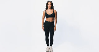 Woman in black TENCEL activewear on clean white background