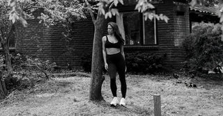 Woman wearing black TENCEL activewear in outdoor setting