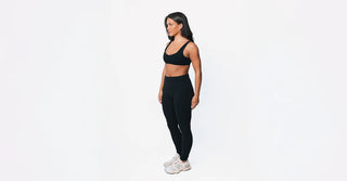 Woman in black TENCEL activewear on clean white background