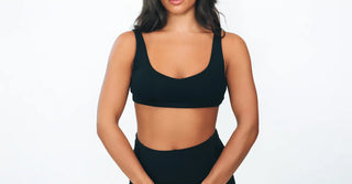 Woman in black TENCEL activewear on clean white background