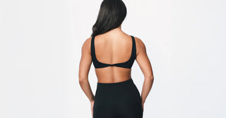 Woman in black TENCEL activewear on clean white background